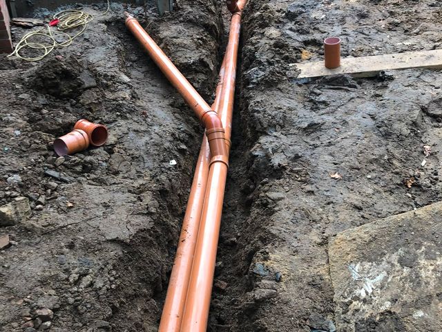 A driveway excavated to depth with a compacted sub-base being built up
