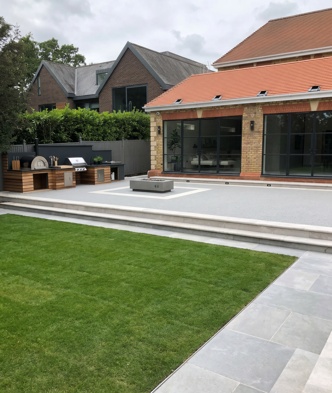 A seamless resin-bound surface tying together a driveway and terrace